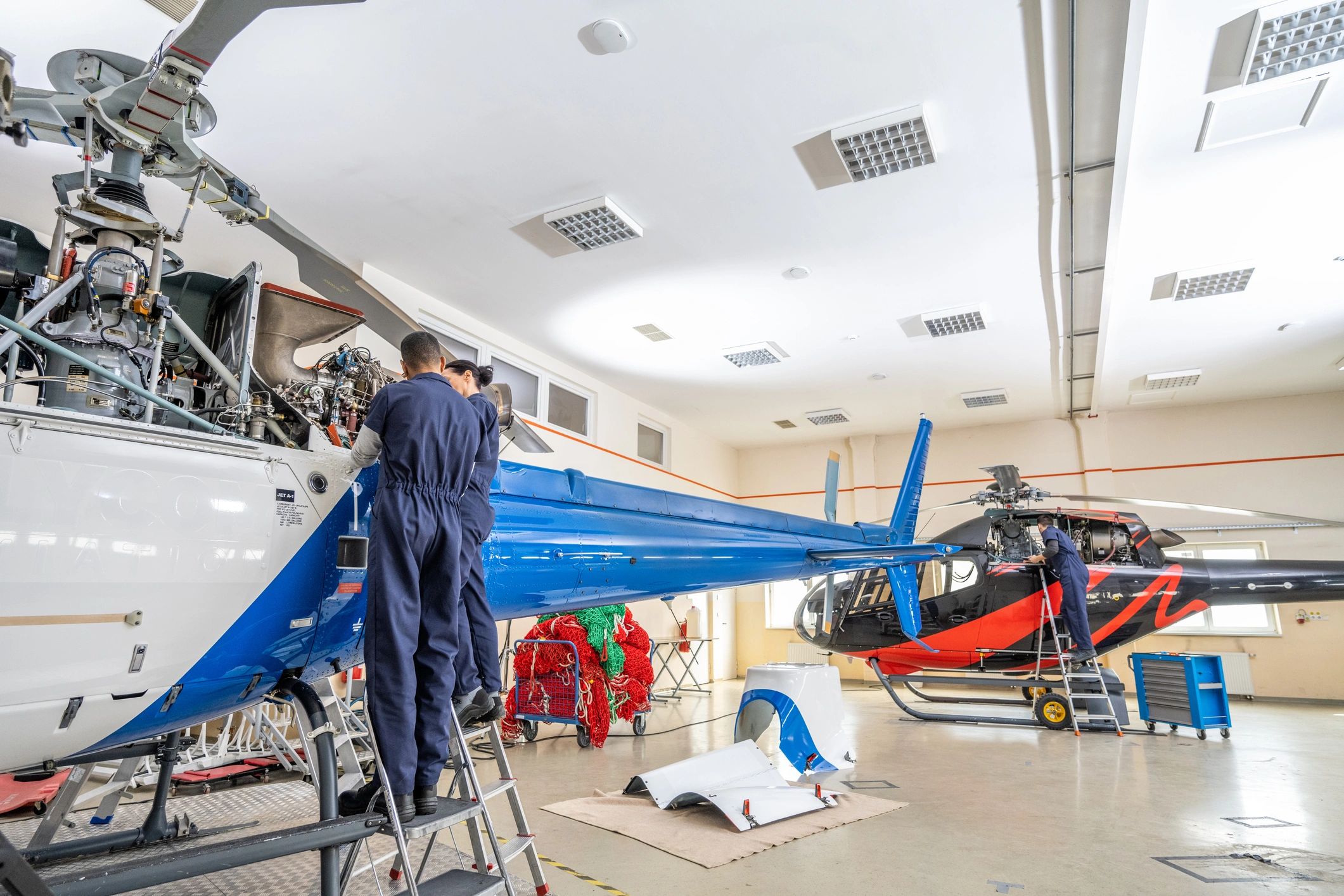 Commercial aircraft maintenance crew working in a large hangar